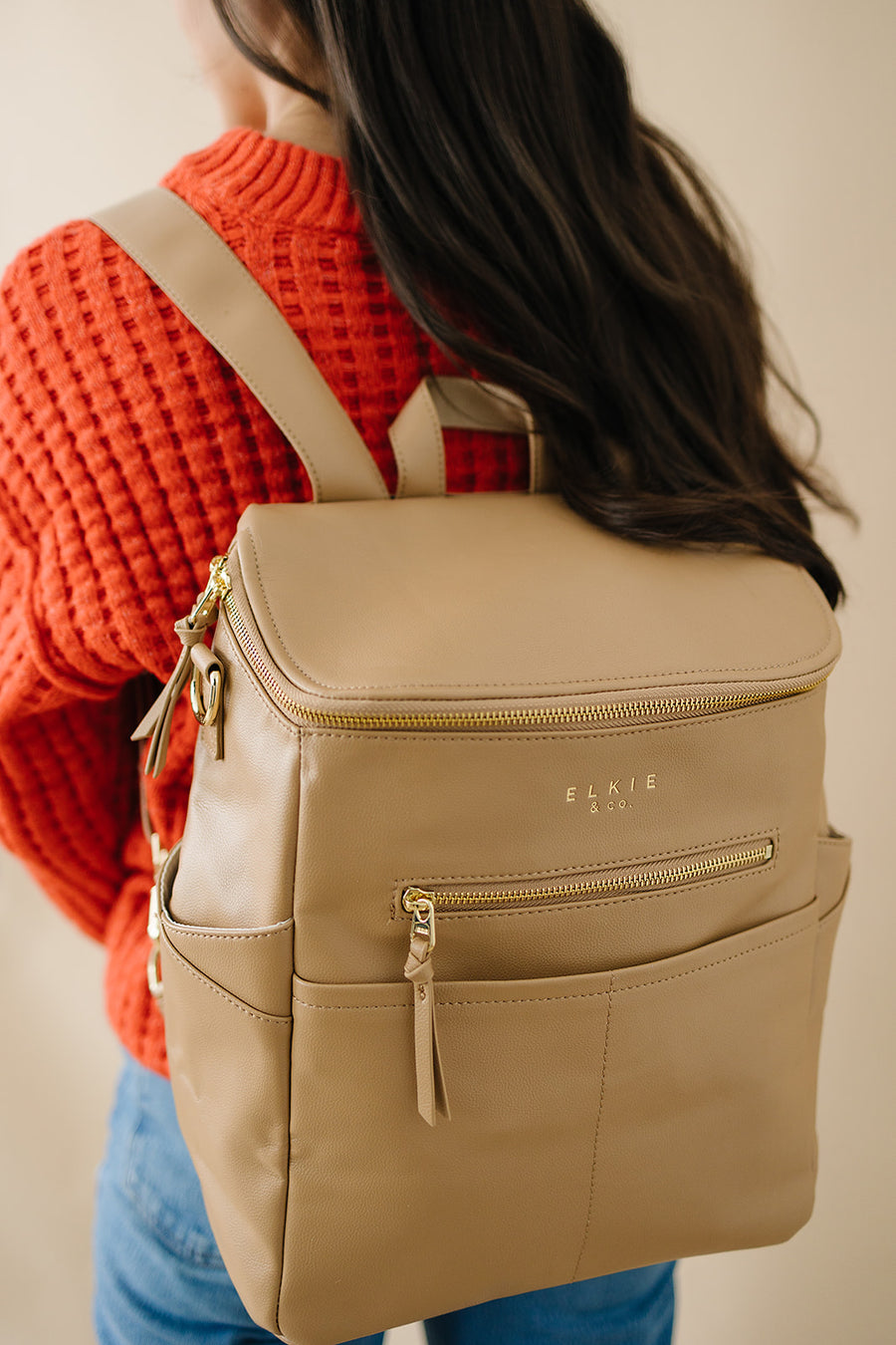 woman wearing Tan capri as backpack