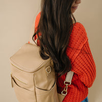 woman wearing Tan capri as backpack. side view