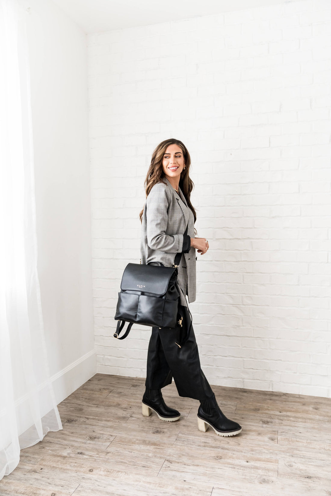 Woman wearing Ebony Milan backpack as crossbody