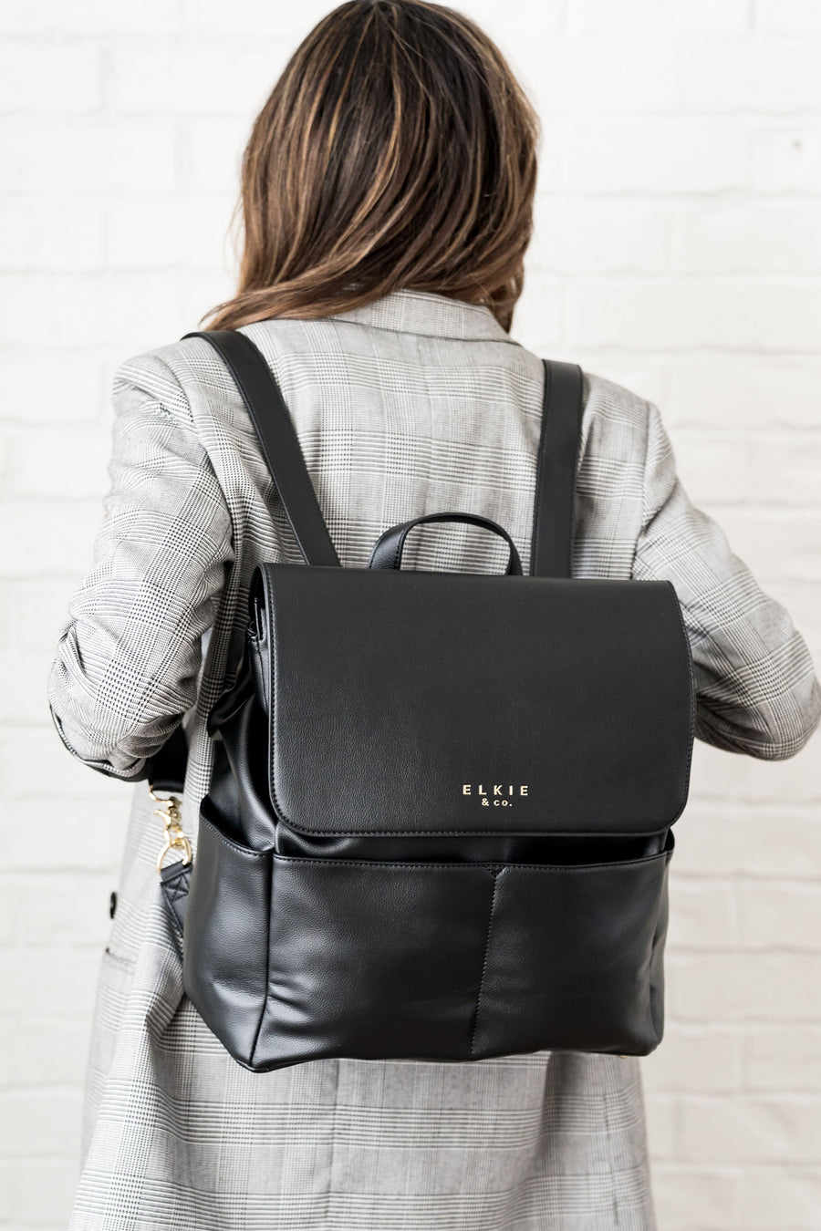 Woman wearing Ebony Milan backpack on back